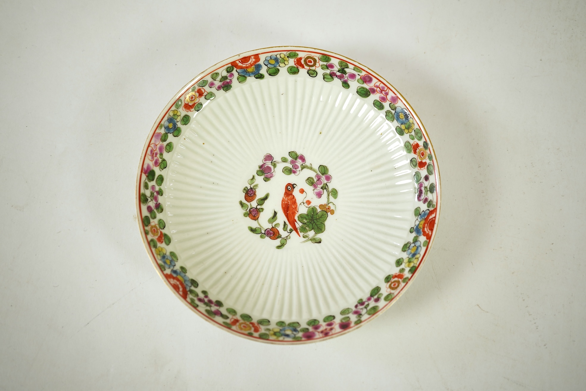 A Worcester Old Worcester Parrot pattern tea bowl and saucer, c.1765-68, saucer 11.5cm in diameter